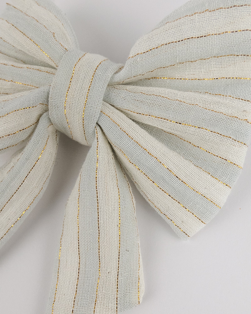 Barrette à noeud rayée et fils brillants or fait main par Atelier Araçari